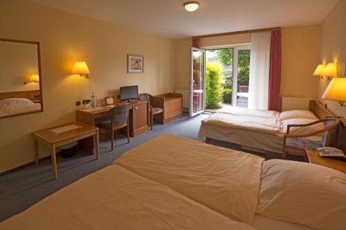 Ένα ή περισσότερα κρεβάτια σε δωμάτιο στο Hotel Wittensee Schützenhof
