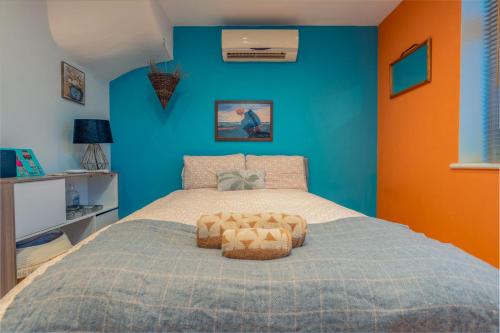 a bedroom with a bed with a blue wall at Charming 2-Bed Flat with Garden in Bristol