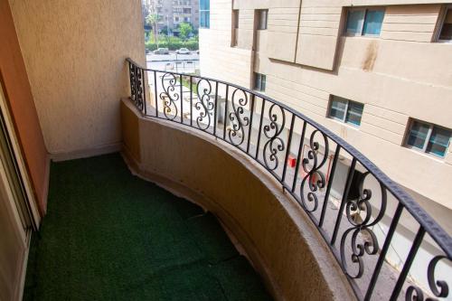 a spiral staircase in a building with a green floor at Cairo Heliopolis Apartment in Cairo