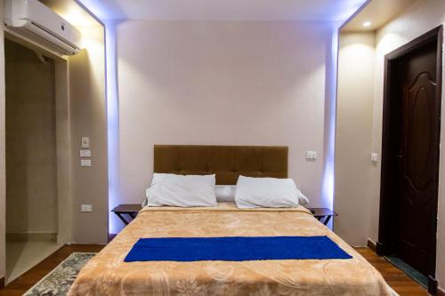 a bedroom with a bed with blue lights on it at Cairo Heliopolis Apartment in Cairo