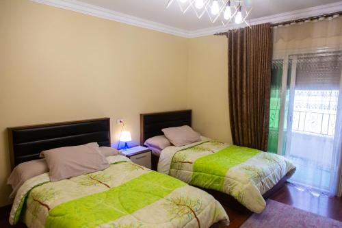 1 Schlafzimmer mit 2 Betten und einem Fenster in der Unterkunft A Family Friendly Apartment in Kairo