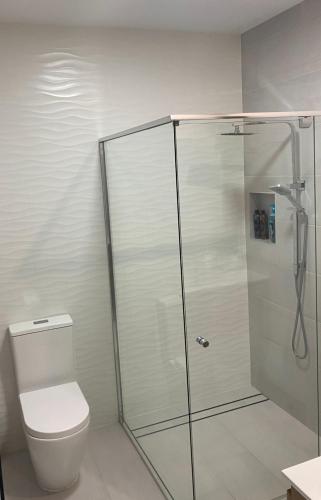 a shower stall with a toilet in a bathroom at Beach House Yeppoon - ARay at Cooee Bay - Apt A in Yeppoon