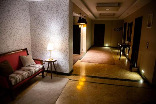 a living room with a couch and a lamp at Cairo Heliopolis Apartment in Cairo
