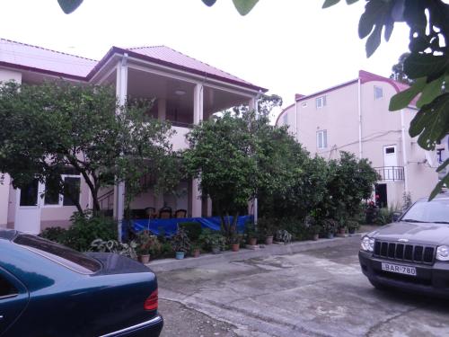 a car parked in a parking lot in front of a house at Guest House Roman/Gonio in Gonio