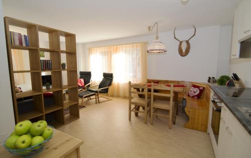 a kitchen and dining room with a table and chairs at Alte Sägerei in Glaris