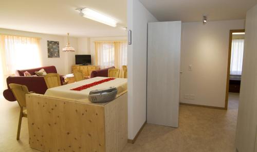 a bedroom with a bed and a living room at Alte Sägerei in Glaris