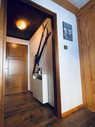 a hallway with a room with a door and a refrigerator at Ferienwohnung Residenza Chesa Margun 34-5 in Surlej