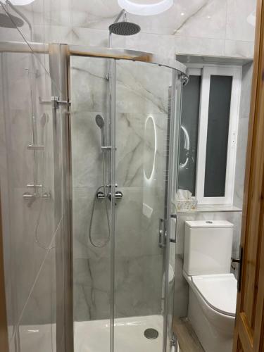 a bathroom with a glass shower with a toilet at Maltese Balcony in St Julian's