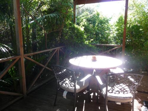a table and chairs on a wooden deck at Orchard Garden in Old Reynella