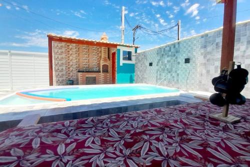 a large swimming pool with a red and white carpet at Refúgio dos Lagos. in Cabo Frio