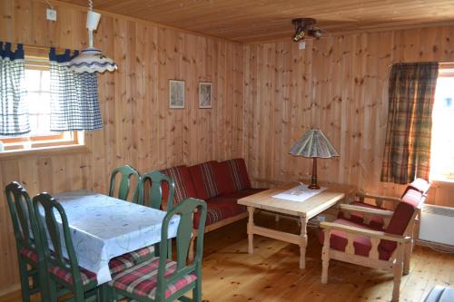 a living room with a table and a couch at Mogard in Skjåk