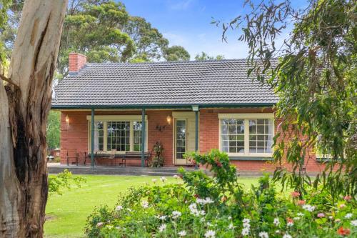 a red brick house with a garden at Spottiswoode - 215 Barclay Road, Myponga in Myponga