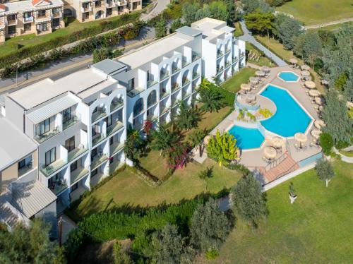 an aerial view of a resort with a swimming pool at Lindos Breeze Beach Hotel in Kiotari