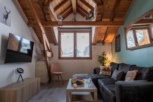 a living room with a couch and a tv at le pragmatique in Guillestre