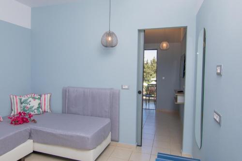 a small bedroom with a bed and a balcony at Lindos Breeze Beach Hotel in Kiotari