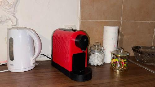 a red toaster sitting on top of a counter at Apartment 70 m² drei Personen Prag kourimka 30 in Prague