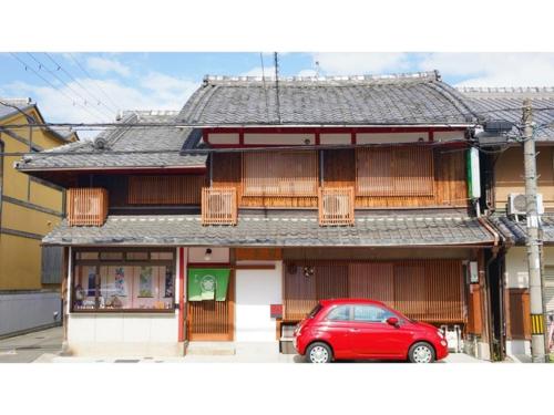 a red car parked in front of a building at Uji Tea Inn - Vacation STAY 27208v in Uji