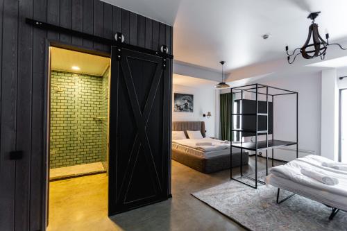 a room with a door leading to a bedroom at Hotel Roshe Gudauri in Gudauri