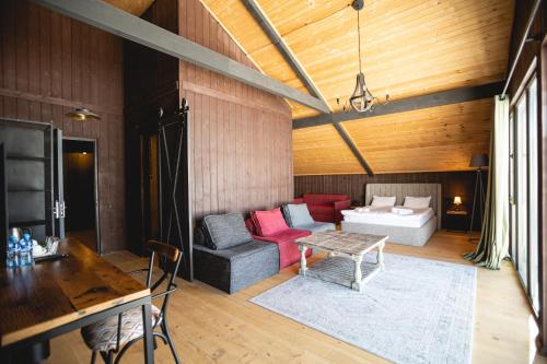 a living room with a couch and a table at Hotel Roshe Gudauri in Gudauri