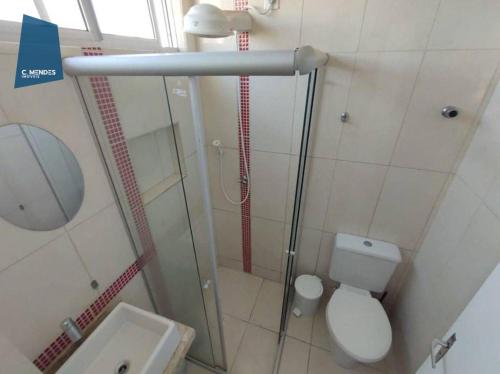 a bathroom with a shower with a toilet and a sink at Apartamento in Fortaleza