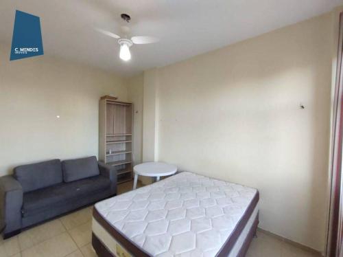 a bedroom with a bed and a couch and a table at Apartamento in Fortaleza