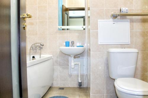 a bathroom with a toilet and a sink at East Time Hotel in Minsk