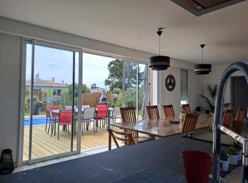 Il comprend une cuisine et une salle à manger avec une terrasse dotée d'une table et de chaises. dans l'établissement Villa familiale, à Port-Joinville