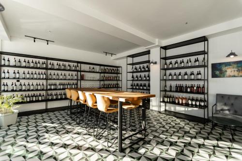 a wine tasting room with a wooden table and chairs at Hotel Roshe Gudauri in Gudauri