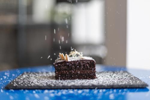 a piece of chocolate cake on a blue table at Hotel Roshe Gudauri in Gudauri