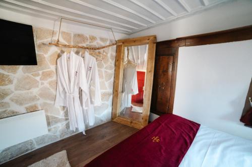 a bedroom with a bed and a stone wall at la foret in Metsovo