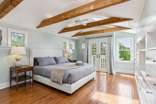 a bedroom with a bed and a ceiling with beams at Modern Provincial Farmhouse I Outdoor Oasis in Chagrin Falls