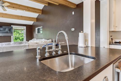 a kitchen with a stainless steel sink in a kitchen at Modern Provincial Farmhouse I Outdoor Oasis in Chagrin Falls