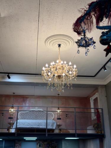 a chandelier hanging from a ceiling in a room at ALL - Amberstone Lux Loft in Klaipėda