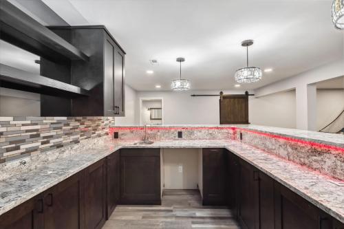 a kitchen with a large counter top and a sink at Great Group Getaway: Games Galore + Outdoor Oasis in Painesville