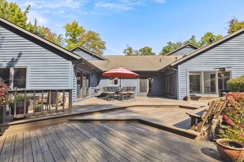 a large wooden deck with a house at Great Group Getaway: Games Galore + Outdoor Oasis in Painesville