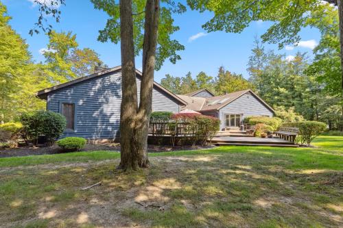a house with a tree in front of it at Great Group Getaway: Games Galore + Outdoor Oasis in Painesville