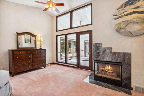 a living room with a fireplace and a window at Great Group Getaway: Games Galore + Outdoor Oasis in Painesville