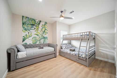 a childs room with a bed and a crib at Amazing Value with High Comfort, 14 Guests for 4BR by Disneyland, Beaches, Rodeo 39 & More in Midway City