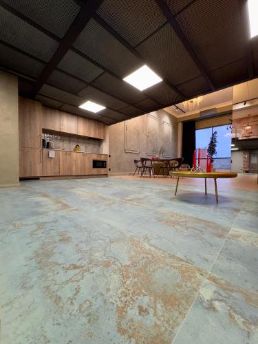 an empty room with a table in the middle at ALL - Amberstone Lux Loft in Klaipėda
