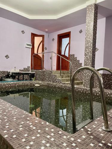 a swimming pool with a reflection of a city at Садиба Карпат in Verkhovyna