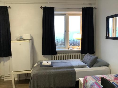 a bedroom with two beds and a window at The Castle in Búðardalur