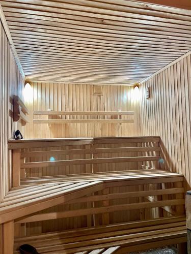 a sauna with wooden benches in a room at Садиба Карпат in Verkhovyna