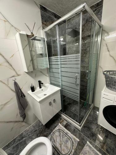 a bathroom with a shower and a toilet and a sink at Lavanda Apartman in Novi Pazar