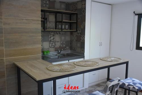 a kitchen with a counter with a sink and a table at Ideas Temporarios in Paso de los Libres