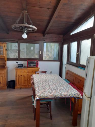 a dining room with a table and a refrigerator at Villetta da Fedro in Leporano