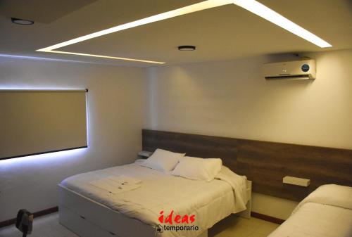 a room with a bed and a projection screen at Ideas Temporarios in Paso de los Libres