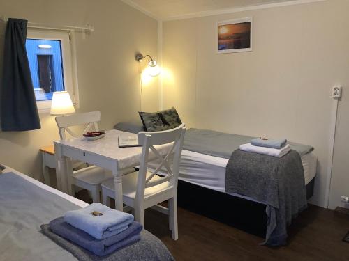 a small room with a bed and a table and chairs at The Castle in Búðardalur