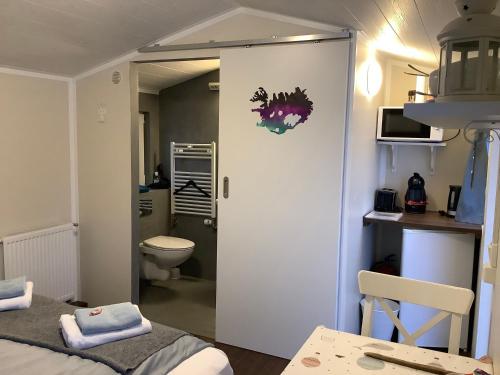 a room with a bathroom with a toilet and a door at The Castle in Búðardalur