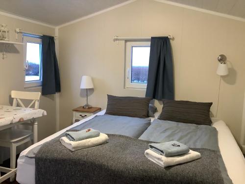 a bedroom with a bed with towels on it at The Castle in Búðardalur
