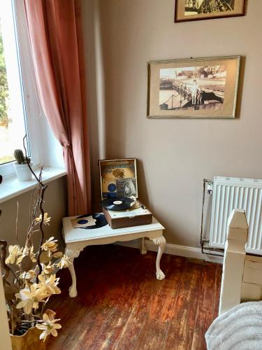 a room with a table with a picture on it at The Old House in Malbork